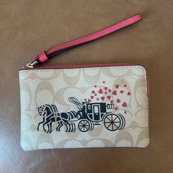 Coach Handbags - COACH Corner Zip Wristlet In Signature Canvas With Horse & Carriage Hearts Motif
